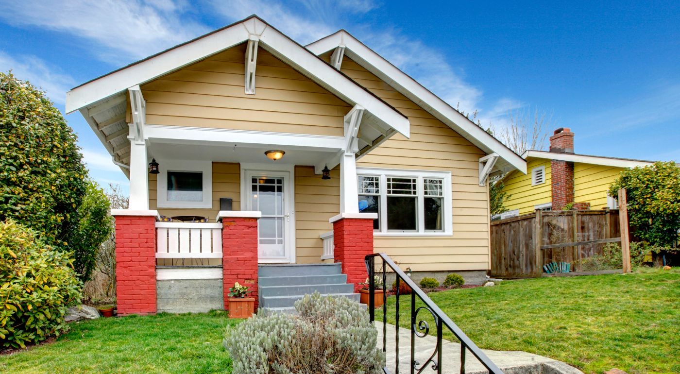 Clapboard siding home with a freshly painted porch and brick columns